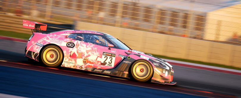 Picture of the Queens' Design Nissan GTR GT3: it is pink with matte black and glossy white accents. On the sides is Victoire Laviolette, Queens' Design mascot.